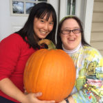 Housemates Edna Tang and Laurie Pippenger show off the pumpkin they picked together. Photo by Bethany Keener